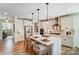 Modern kitchen with white cabinets, quartz countertops and island at Lot 22 Devonshire Rd # 22, Denver, NC 28037