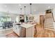 Open concept kitchen with island, stainless steel appliances and stairs at Lot 22 Devonshire Rd # 22, Denver, NC 28037