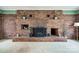 Brick fireplace with a decorative mantel and built-in shelving units on either side at 3811 Sherer Rd, Sharon, SC 29742
