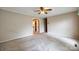 Spacious bedroom with neutral walls, carpet flooring, ceiling fan, and access to a hallway at 3811 Sherer Rd, Sharon, SC 29742