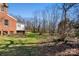 Brick home with deck overlooking a spacious backyard and wooded area at 615 Peach St, Shelby, NC 28150