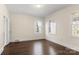 Bright bedroom with hardwood floors and multiple windows at 615 Peach St, Shelby, NC 28150