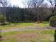Landscaped front yard with driveway leading to the house at 615 Peach St, Shelby, NC 28150