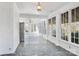Sunroom with flagstone floor, lots of windows, and a refrigerator at 615 Peach St, Shelby, NC 28150