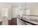 Upper hallway with hardwood floors and access to bedrooms at 615 Peach St, Shelby, NC 28150