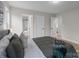 Bright bedroom with a queen bed, striped bedding, and access to a bathroom at 310 New Bern Ave, Statesville, NC 28677