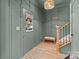 Stylish entryway with green walls, wooden bench, and stairs at 310 New Bern Ave, Statesville, NC 28677