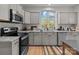 Modern kitchen with stainless steel appliances and island at 310 New Bern Ave, Statesville, NC 28677
