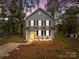 Two-story house with gray siding, black shutters, and a yellow front door at 310 New Bern Ave, Statesville, NC 28677