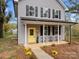 Two-story house with gray siding, black shutters, and a yellow front door at 310 New Bern Ave, Statesville, NC 28677