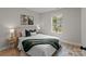 Cozy bedroom with a queen bed, neutral decor, and a window overlooking the backyard at 310 New Bern Ave, Statesville, NC 28677