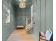 Entryway with green walls, wooden stairs, and a bench at 310 New Bern Ave, Statesville, NC 28677