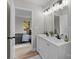 Double vanity bathroom with modern light fixtures and a view into a bedroom at 310 New Bern Ave, Statesville, NC 28677