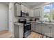 Modern kitchen with stainless steel appliances and island at 310 New Bern Ave, Statesville, NC 28677