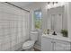 Clean bathroom with white vanity, shower/tub combo, and patterned shower curtain at 310 New Bern Ave, Statesville, NC 28677