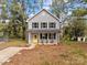 Two-story house with gray siding and yellow door at 310 New Bern Ave, Statesville, NC 28677