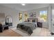 Spacious bedroom with a queen bed, large windows, and hardwood floors at 310 New Bern Ave, Statesville, NC 28677