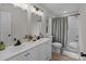 Modern bathroom with double vanity, updated light fixtures, and a tub shower at 310 New Bern Ave, Statesville, NC 28677