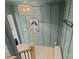 Entryway with a light green wall, wood-look floors and stylish light fixture at 310 New Bern Ave, Statesville, NC 28677