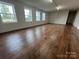 Large living room with hardwood floors and four windows at 3923 Old Pageland Monroe Rd, Monroe, NC 28112