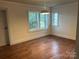 A bright dining room with hardwood floors and two windows at 3923 Old Pageland Monroe Rd, Monroe, NC 28112