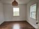 Bedroom with hardwood floors, white walls, and two windows at 3923 Old Pageland Monroe Rd, Monroe, NC 28112