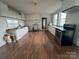Kitchen with white cabinets, black appliances, and hardwood floors at 3923 Old Pageland Monroe Rd, Monroe, NC 28112