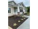 House exterior features a covered porch, stone pillars, and landscaping at 501 Chestnut Grove Rd, Statesville, NC 28625