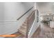 Elegant staircase with a metal railing and neutral carpeting at 1205 Red River Dr, Salisbury, NC 28144