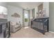 Charming Bedroom with crib and ample natural light at 1205 Red River Dr, Salisbury, NC 28144