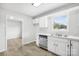 Modern kitchen featuring white cabinets, stainless steel appliances, and a window at 215 Bethesda Rd, Statesville, NC 28677