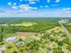 Aerial view showcasing a large undeveloped lot with surrounding houses and roads at 215 Bethesda Rd, Statesville, NC 28677