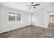 Spacious living area featuring vinyl flooring and ceiling fan at 215 Bethesda Rd, Statesville, NC 28677