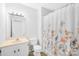 Clean bathroom with floral shower curtain and white vanity at 215 Bethesda Rd, Statesville, NC 28677