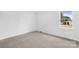 Bright bedroom with grey carpet and backyard view at 215 Bethesda Rd, Statesville, NC 28677