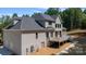 Two-story home with gray brick exterior and deck at 6212 River Birch Dr, Gastonia, NC 28056