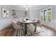 Dining room with hardwood floors, built-in shelves, and a modern light fixture at 6212 River Birch Dr, Gastonia, NC 28056