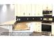 Kitchen boasts light cabinets, granite counters, and a dark tile backsplash at 00 Wilson Ct # 16, Lincolnton, NC 28092