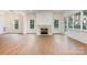 Bright living room features hardwood floors, fireplace, and multiple windows at 4013 Nettie Ct # 6, Charlotte, NC 28211