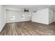 Bright living room with large windows, wood-look flooring, and white walls at 1977 Ripplerock Rd, Fort Mill, SC 29715