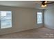 Well-lit bedroom with two windows offering natural light and carpet at 1005 Dawn Light Rd, Indian Trail, NC 28079