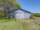 Grey metal barn on a grassy lot near trees at 112 W Highway 218 Rd, Monroe, NC 28110