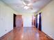 Spacious bedroom with hardwood floors and ceiling fan at 112 W Highway 218 Rd, Monroe, NC 28110