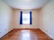 Simple bedroom with hardwood floors and a window at 112 W Highway 218 Rd, Monroe, NC 28110