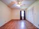 Hardwood floors, ceiling fan, and double doors to closet at 112 W Highway 218 Rd, Monroe, NC 28110