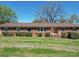 Brick ranch house featuring a classic design and landscaping at 112 W Highway 218 Rd, Monroe, NC 28110