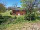 Brick house with a partially visible yard and trees at 112 W Highway 218 Rd, Monroe, NC 28110
