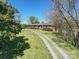 Brick ranch house with a long driveway and spacious yard at 112 W Highway 218 Rd, Monroe, NC 28110