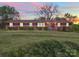 Ranch style home with brick facade and well-manicured lawn at 112 W Highway 218 Rd, Monroe, NC 28110