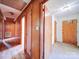 Hallway with wood paneled walls and wood floors at 112 W Highway 218 Rd, Monroe, NC 28110